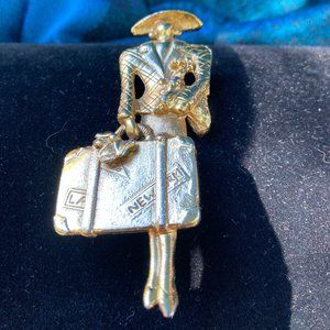 Gold tone The Traveler and Her Dog brooch
